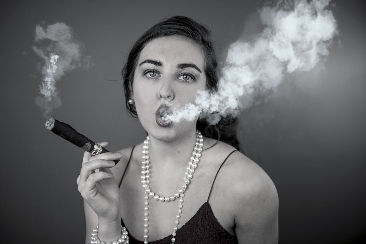 Black and white portrait with pearls and swirling smoke